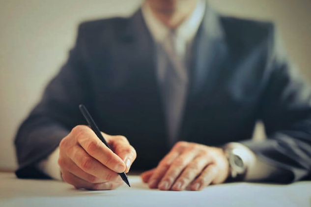 A first year lawyer signing a document