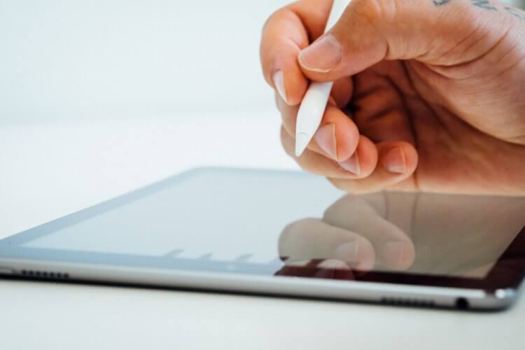 A photo of someone using an iPad to automate documents