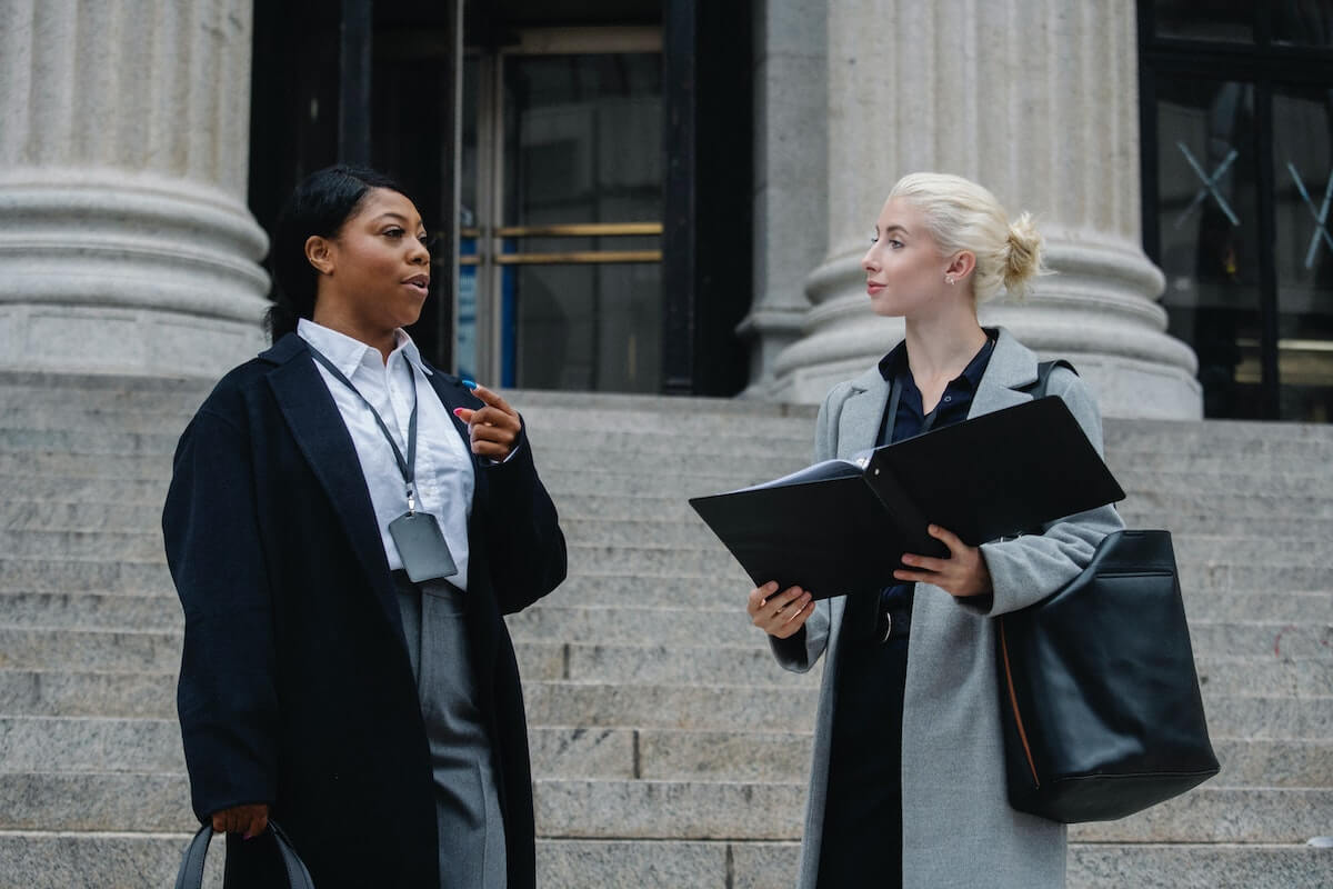 Defense lawyer prepping client at courthouse