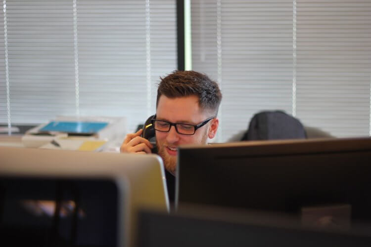 A photo of a paralegal on the phone with a legal translation company