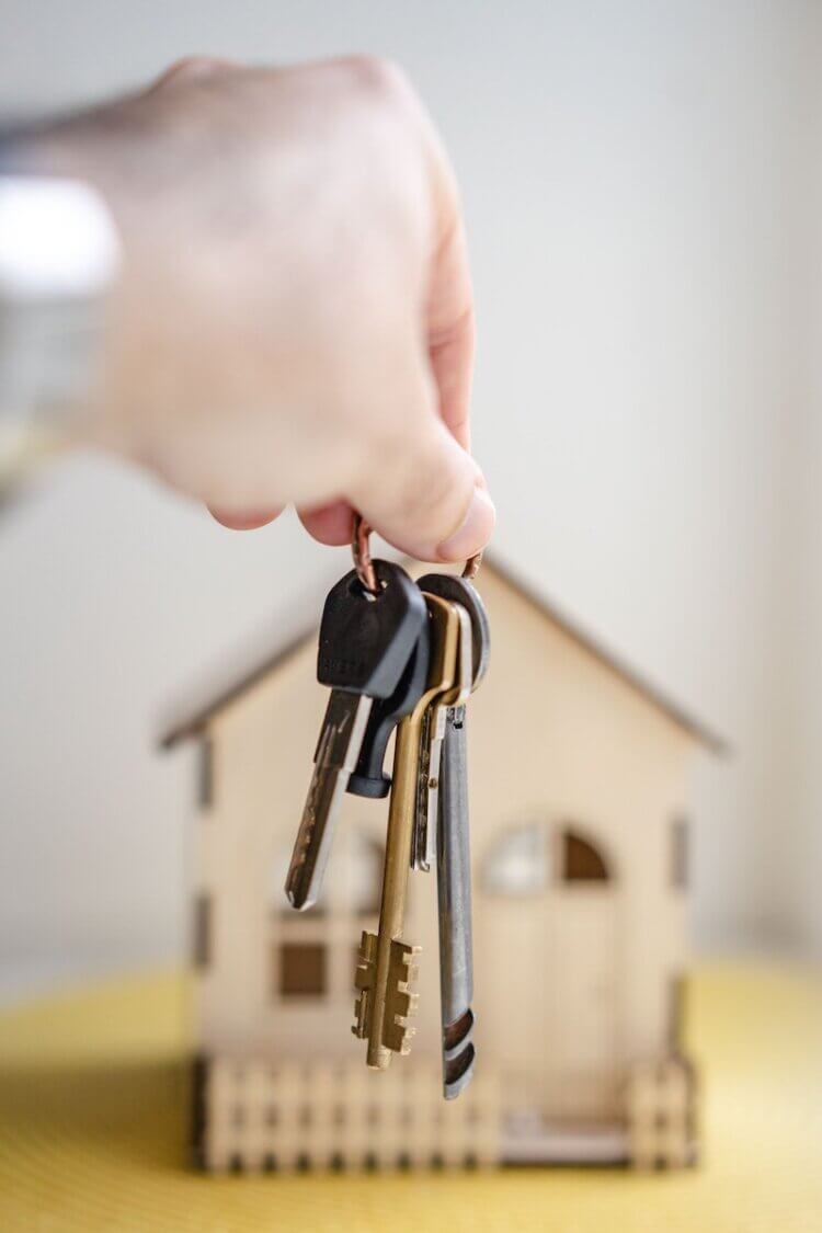 House keys in front of a model house
